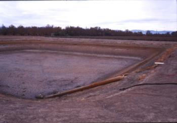Drained reservoir used for settling iron from groundwater source.  Photo:  L. Schwankl