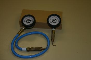 Pressure gauges with attached pitot tubes for measuring pressure inside drip tubing.  Photo: L. Schwankl.