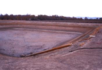 Empty storage reservoir used to settle out precipitated iron from a high iron groundwater source.  Photo: L. Schwankl